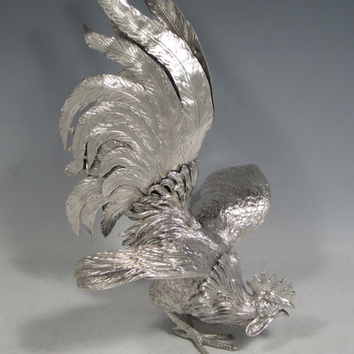 A very handsome Sterling Silver large pair of cast fighting cock cockerels or roosters, showing two male birds in realistic fighting poses, finely detailed with hand-chased bodies and tail feathers. This fantastic pair of silver fighting cocks were made by Francis Higgins of London in 1936. The dimensions of these fine hand-made sterling silver fighting roosters or cockerel cocks are length 30.5 cms (12 inches), height 27 cms (10.75 inches), and they weigh a total of approx. 1,240g (40 troy ounces).
