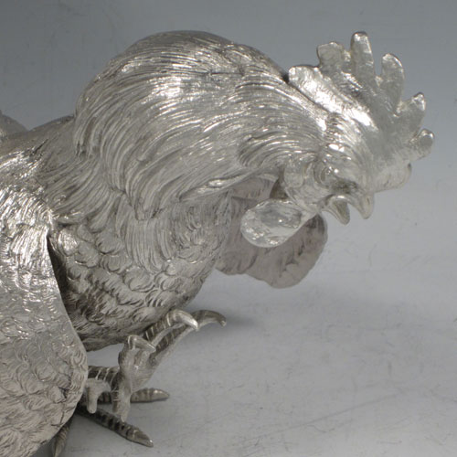 A very handsome Sterling Silver large pair of cast fighting cock cockerels or roosters, showing two male birds in realistic fighting poses, finely detailed with hand-chased bodies and tail feathers. This fantastic pair of silver fighting cocks were made by Francis Higgins of London in 1936. The dimensions of these fine hand-made sterling silver fighting roosters or cockerel cocks are length 30.5 cms (12 inches), height 27 cms (10.75 inches), and they weigh a total of approx. 1,240g (40 troy ounces).