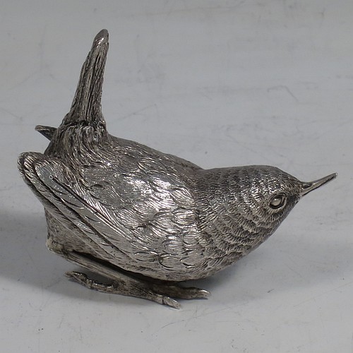 A cast Sterling Silver model of a Wren bird, in a realistic traditional pose, finely detailed with hand-chased body and tail feathers. Made by Robert Glover of London in 1974. The dimensions of this fine hand-made cast sterling silver wren model are length 6 cs (2.3 inches), height 5 cms (2 inches), width 2.5 cms (1 inch), and it weighs approx. 163g (5.25 troy ounces).