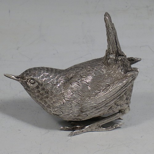 A cast Sterling Silver model of a Wren bird, in a realistic traditional pose, finely detailed with hand-chased body and tail feathers. Made by Robert Glover of London in 1974. The dimensions of this fine hand-made cast sterling silver wren model are length 6 cs (2.3 inches), height 5 cms (2 inches), width 2.5 cms (1 inch), and it weighs approx. 163g (5.25 troy ounces).