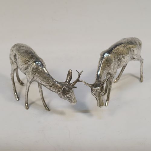 A very handsome Antique Edwardian Sterling Silver pair of solid cast deer, showing a male stag and female doe in realistic traditional poses, all finely detailed with hand-chased bodies. This  beautiful pair of silver deer were originally made on the Continent and imported with full hallmarks for London in 1902. The dimensions of these fine hand-made sterling silver deer are height of male stag  7.5 cms (3 inches), length of female doe 12 cms (4.75 inches), and they weigh a total approx. 275g (8.9 troy ounces).   