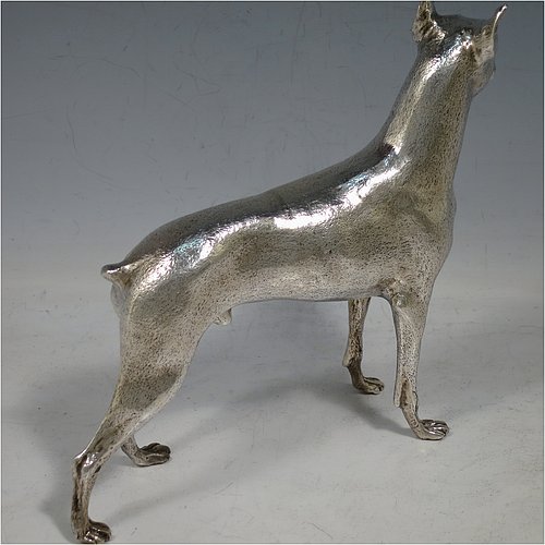 A large cast 800 Standard Silver model of a Doberman Pinscher dog, having a realistically hand-chased body. Made in Europe in ca. 1910. The dimensions of this fine hand-made 800 standard silver Doberman Pinscher dog model are height 17 cms (6.75 inches), length 19 cms (7.5 inches), width 5 cms (2.5 inches), and it weighs approx. 430g (13.9 troy ounces).    