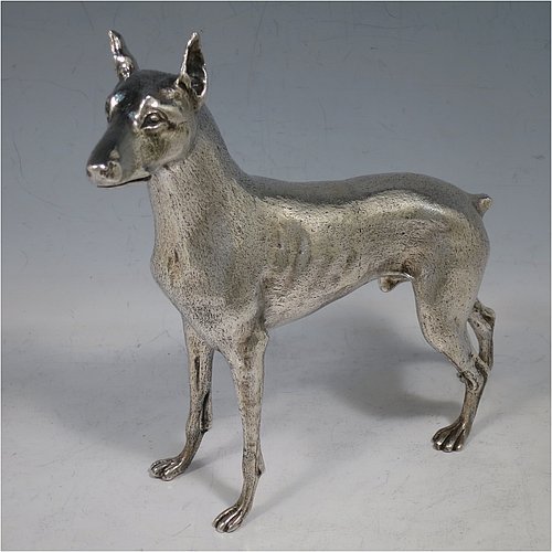 A large cast 800 Standard Silver model of a Doberman Pinscher dog, having a realistically hand-chased body. Made in Europe in ca. 1910. The dimensions of this fine hand-made 800 standard silver Doberman Pinscher dog model are height 17 cms (6.75 inches), length 19 cms (7.5 inches), width 5 cms (2.5 inches), and it weighs approx. 430g (13.9 troy ounces).    