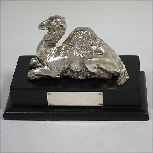 A very unusual and handsome Antique Victorian Sterling Silver pair of cast camels, attached to rectangular stepped plinths with silver inscription panels, and with finely detailed hand-chased bodies in sitting position. Made for the Grocers Guild by Alexander MacRae of London in ca. 1880. The dimensions of these fine hand-made sterling silver camels on plinths are length 13.5 cms (5.3 inches), width 7.5 cms (3 inches), and height 9 cms (3.5 inches).