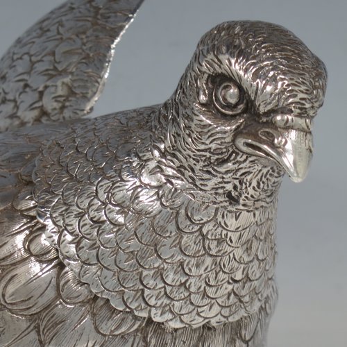 A Sterling Silver large cast model of a partridge bird, having realistically hand-chased feathers, a pull-off head, and hinged wings. Imported and having hallmarks for London in 1925. The dimensions of this fine hand-made silver partridge model are height 16.5 cms (6.5 inches), length 16.5 cms (6.5 inches), width 9 cms (3.5 inches), and it weighs approx. 435g (14 troy ounces).