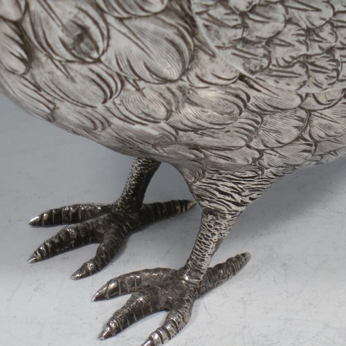 A Sterling Silver large cast model of a partridge bird, having realistically hand-chased feathers, a pull-off head, and hinged wings. Imported and having hallmarks for London in 1925. The dimensions of this fine hand-made silver partridge model are height 16.5 cms (6.5 inches), length 16.5 cms (6.5 inches), width 9 cms (3.5 inches), and it weighs approx. 435g (14 troy ounces).