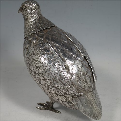 A Sterling Silver large cast model of a partridge bird, having realistically hand-chased feathers, a pull-off head, and hinged wings. Imported and having hallmarks for London in 1925. The dimensions of this fine hand-made silver partridge model are height 16.5 cms (6.5 inches), length 16.5 cms (6.5 inches), width 9 cms (3.5 inches), and it weighs approx. 435g (14 troy ounces).