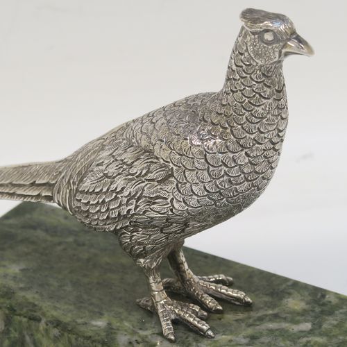 A very handsome cast Sterling Silver model of a pheasant, showing a male bird in a realistic traditional pose, finely detailed with hand-chased body and tail feathers, all mounted on a green Connemara marble base. This beautiful cast silver pheasant model bird was made by A. E. Jones of Birmingham in 1968. The dimensions of this fine hand-made cast silver pheasant 16.5 cms (6.5 inches), height 10 cms (4 inches), with an aprrox. weight of 250g (8 troy ounces.
