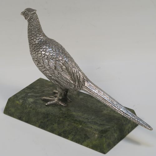 A very handsome cast Sterling Silver model of a pheasant, showing a male bird in a realistic traditional pose, finely detailed with hand-chased body and tail feathers, all mounted on a green Connemara marble base. This beautiful cast silver pheasant model bird was made by A. E. Jones of Birmingham in 1968. The dimensions of this fine hand-made cast silver pheasant 16.5 cms (6.5 inches), height 10 cms (4 inches), with an aprrox. weight of 250g (8 troy ounces.