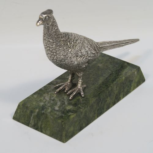 A very handsome cast Sterling Silver model of a pheasant, showing a male bird in a realistic traditional pose, finely detailed with hand-chased body and tail feathers, all mounted on a green Connemara marble base. This beautiful cast silver pheasant model bird was made by A. E. Jones of Birmingham in 1968. The dimensions of this fine hand-made cast silver pheasant 16.5 cms (6.5 inches), height 10 cms (4 inches), with an aprrox. weight of 250g (8 troy ounces.