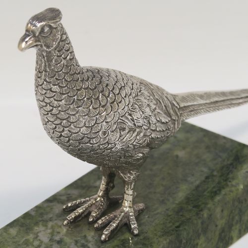 A very handsome cast Sterling Silver model of a pheasant, showing a male bird in a realistic traditional pose, finely detailed with hand-chased body and tail feathers, all mounted on a green Connemara marble base. This beautiful cast silver pheasant model bird was made by A. E. Jones of Birmingham in 1968. The dimensions of this fine hand-made cast silver pheasant 16.5 cms (6.5 inches), height 10 cms (4 inches), with an aprrox. weight of 250g (8 troy ounces.