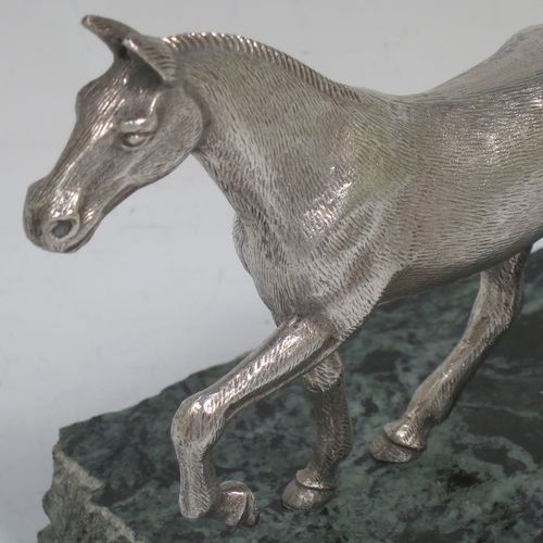 A handsome Sterling Silver cast model of a horse in a cantering pose, and fixed to a green marble base. Made by Albert Edward Jones of Birmingham in 1972. The dimensions of this fine hand-made silver horse are height 11.5 cms (4.5 inches), and length 15 cms (6 inches).   