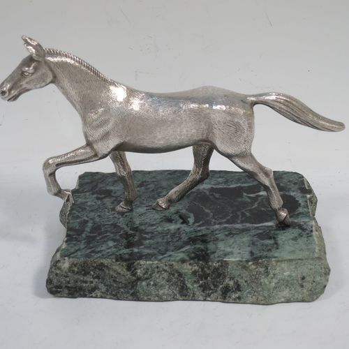A handsome Sterling Silver cast model of a horse in a cantering pose, and fixed to a green marble base. Made by Albert Edward Jones of Birmingham in 1972. The dimensions of this fine hand-made silver horse are height 11.5 cms (4.5 inches), and length 15 cms (6 inches).   