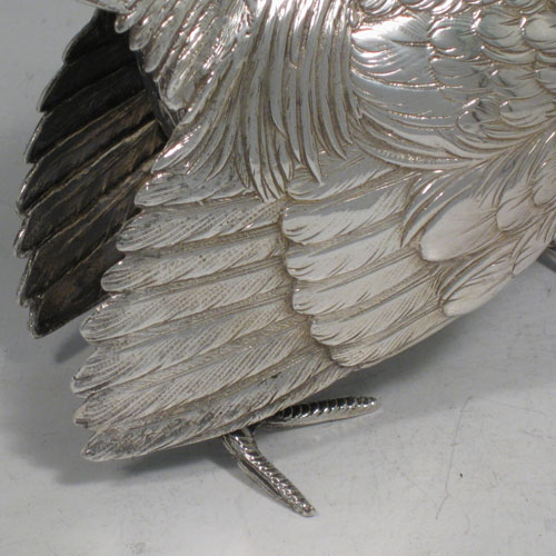 Sterling silver large cast model of a pheasant cock bird, having realistically hand-chased feathers. Imported and having hallmarks for London in 1926. Height 21.5 cms (8.5 inches), length 35 cms (13.75 inches), width 8 cms (3 inches). Weight approx. 412g (13.3 troy ounces).