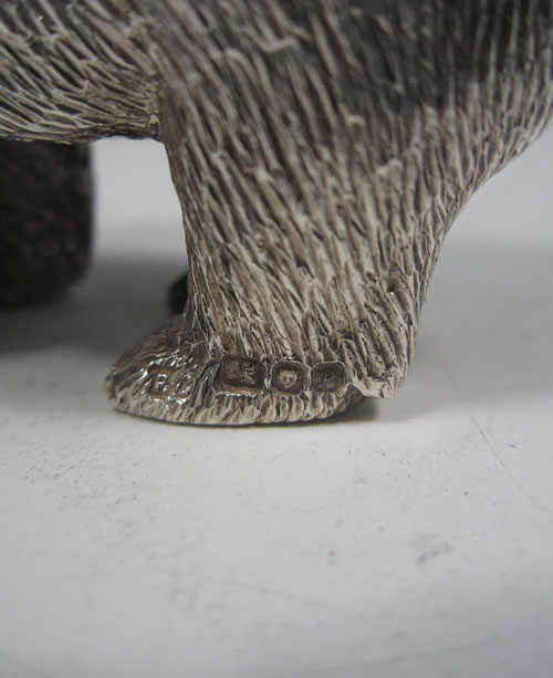 Sterling silver cast model of a standing polar bear, having realistically hand-chased fur, with fine detail. Made by Robert Comyns of London in 1989. The dimensions of this fine hand-made silver polar bear are length 9 cms (3.5 inches), height 4.5 cms (1.75 inches), and it weighs approx. 160g (5.2 troy ounces).