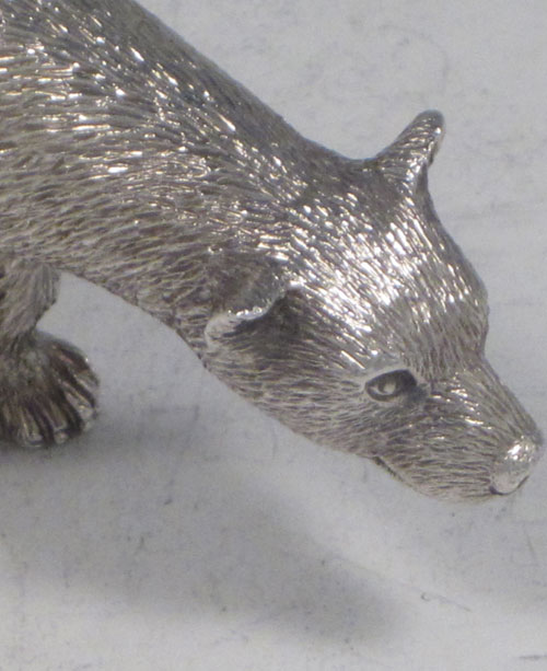 Sterling silver cast model of a standing polar bear, having realistically hand-chased fur, with fine detail. Made by Robert Comyns of London in 1989. The dimensions of this fine hand-made silver polar bear are length 9 cms (3.5 inches), height 4.5 cms (1.75 inches), and it weighs approx. 160g (5.2 troy ounces).