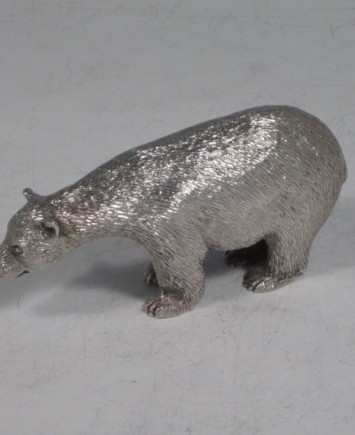 Sterling silver cast model of a standing polar bear, having realistically hand-chased fur, with fine detail. Made by Robert Comyns of London in 1989. The dimensions of this fine hand-made silver polar bear are length 9 cms (3.5 inches), height 4.5 cms (1.75 inches), and it weighs approx. 160g (5.2 troy ounces).