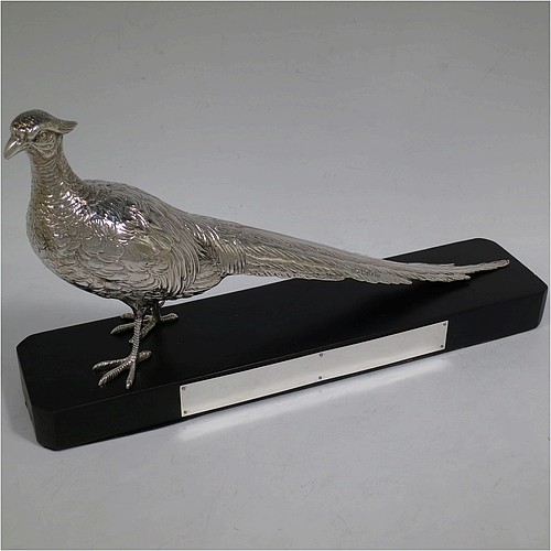 A very handsome cast Sterling Silver single pheasant model, showing a male bird in a realistic traditional pose, finely detailed with hand-chased body and tail feathers, and all sitting on a black presentation plinth with silver plaque. Made by Jones and Son of London in 1935. The dimensions of this fine hand-made sterling silver pheasant are length 30.5 cms (12 inches), height 13.5 cms (5.3 inches), and it weighs approx. 465g (15 troy ounces).    