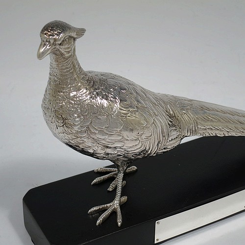 A very handsome cast Sterling Silver single pheasant model, showing a male bird in a realistic traditional pose, finely detailed with hand-chased body and tail feathers, and all sitting on a black presentation plinth with silver plaque. Made by Jones and Son of London in 1935. The dimensions of this fine hand-made sterling silver pheasant are length 30.5 cms (12 inches), height 13.5 cms (5.3 inches), and it weighs approx. 465g (15 troy ounces).