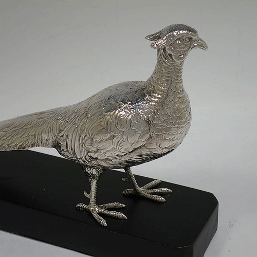 A very handsome cast Sterling Silver single pheasant model, showing a male bird in a realistic traditional pose, finely detailed with hand-chased body and tail feathers, and all sitting on a black presentation plinth with silver plaque. Made by Jones and Son of London in 1935. The dimensions of this fine hand-made sterling silver pheasant are length 30.5 cms (12 inches), height 13.5 cms (5.3 inches), and it weighs approx. 465g (15 troy ounces).