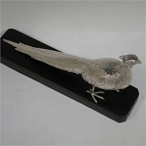 A very handsome cast Sterling Silver single pheasant model, showing a male bird in a realistic traditional pose, finely detailed with hand-chased body and tail feathers, and all sitting on a black presentation plinth with silver plaque. Made by Jones and Son of London in 1935. The dimensions of this fine hand-made sterling silver pheasant are length 30.5 cms (12 inches), height 13.5 cms (5.3 inches), and it weighs approx. 465g (15 troy ounces).