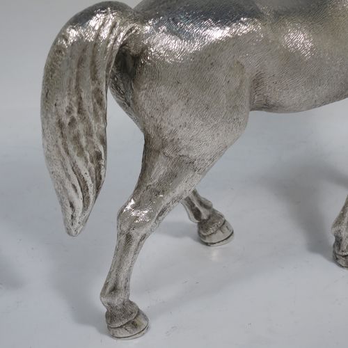 A very handsome, large, and heavy Sterling Silver cast model of a horse in a standing pose, all realistically hand-chased. Made by SMD Castings of London in 1973. The dimensions of this fine hand-made silver horse are height 20 cms (8 inches), length 24 cms (9.5 inches), and it weighs approx. 1,310g (42 troy ounces).