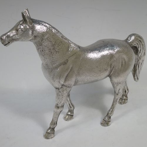 A very handsome, large, and heavy Sterling Silver cast model of a horse in a standing pose, all realistically hand-chased. Made by SMD Castings of London in 1973. The dimensions of this fine hand-made silver horse are height 20 cms (8 inches), length 24 cms (9.5 inches), and it weighs approx. 1,310g (42 troy ounces).