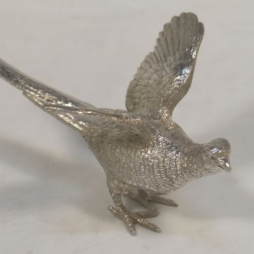 A very handsome Sterling Silver pair of solid cast pheasants, showing a male and female bird in realistic traditional poses, finely detailed with hand-chased bodies and tail feathers. These beautiful silver pheasants were made by C. J. Vander of Sheffield in 1995. The dimensions of these fine hand-made sterling silver pheasants are length of female bird 13.5 cms (5.25 inches), spread across wings 8 cms (6 inches), height of male bird to top of head 6 cms (2.3 inches), and they weigh a total approx. 305g (9.8 troy ounces).
