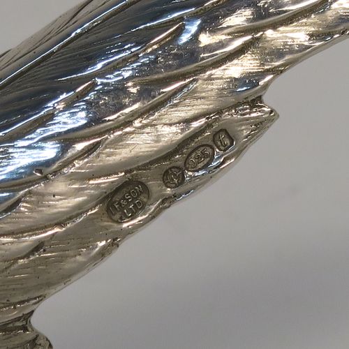 A very handsome Sterling Silver pair of solid cast pheasants, showing a male and female bird in realistic traditional poses, finely detailed with hand-chased bodies and tail feathers. These beautiful silver pheasants were made by I. Freeman of London in 1974. The dimensions of these fine hand-made sterling silver pheasants are length of female bird 19 cms (7.5 inches), spread across wings 12 cms (4.75 inches), height of male bird to top of head 9 cms (3.5 inches), and they weigh a total approx. 320g (10.3 troy ounces).
