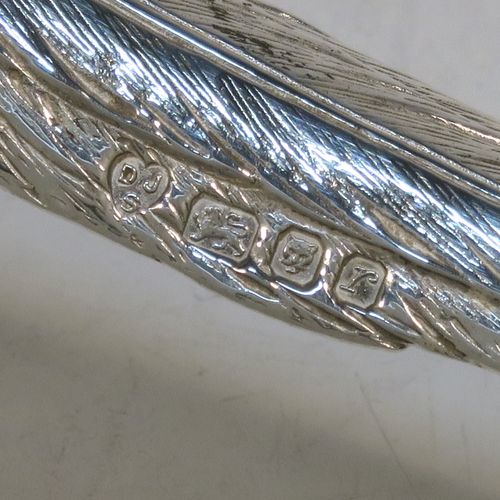 A very handsome Sterling Silver pair of cast pheasants, showing a male and female bird in realistic traditional poses, finely detailed with hand-chased bodies and tail feathers. These beautiful silver pheasants were made by D. J. Silver of London in 1972. The dimensions of these fine hand-made sterling silver pheasants are length of female bird 23 cms (9 inches), spread across wings 15 cms (6 inches), height of male bird to top of head 8 cms (3 inches), and they weigh a total approx. 815g (26.3 troy ounces).