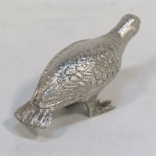 A handsome Sterling Silver solid cast model of a partridge bird, in a pose and having realistically hand-chased feathers. This elegant silver partridge model was made by Robert Comyns of London in 1971. The dimensions of this fine hand-made silver partridge model are height 3.5 cms (1.3 inches), length 7.5 cms (3 inches), width 3 cms (1.25 inches), and it weighs approx. 51g (1.6 troy ounces).