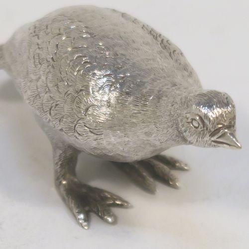 A handsome Sterling Silver solid cast model of a partridge bird, in a pose and having realistically hand-chased feathers. This elegant silver partridge model was made by Robert Comyns of London in 1971. The dimensions of this fine hand-made silver partridge model are height 3.5 cms (1.3 inches), length 7.5 cms (3 inches), width 3 cms (1.25 inches), and it weighs approx. 51g (1.6 troy ounces).