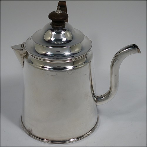An Antique Edwardian Silver Plated Argyll, having a plain round body with tapering sides and applied reeded borders, a stepped pull-off lid with wooden finial, a scroll pouring spout, a wooden scroll handle, a separate side spout with hinged lid for adding hot water to the water jacket, and all sitting on a flat base. Made in ca. 1910. The dimensions of this fine hand-made antique silver-plated Argyll are height 15 cms (6 inches), diameter at base 10 cms (4 inches), and length across spouts 15 cms (6 inches).