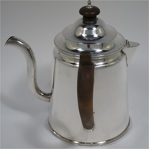 An Antique Edwardian Silver Plated Argyll, having a plain round body with tapering sides and applied reeded borders, a stepped pull-off lid with wooden finial, a scroll pouring spout, a wooden scroll handle, a separate side spout with hinged lid for adding hot water to the water jacket, and all sitting on a flat base. Made in ca. 1910. The dimensions of this fine hand-made antique silver-plated Argyll are height 15 cms (6 inches), diameter at base 10 cms (4 inches), and length across spouts 15 cms (6 inches).