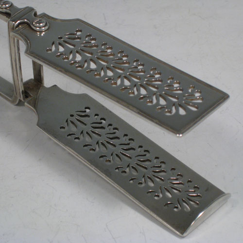 Antique Victorian sterling silver Fiddle and Thread pattern pair of asparagus serving tongs, having hand-pierced blades, and original retaining guard with screws. Made by Mary Chawner of London in 1838. The dimensions of this fine pair of antique silver asparagus servers are length 26 cms (10.25 inches), and they weigh approx. 215g (6.9 troy ounces). Please note that this item is crested.