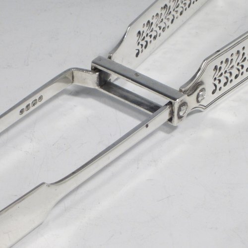 Antique Georgian sterling silver Fiddle pattern pair of asparagus serving tongs, having hand-pierced blades, and original retaining guard with screws. Made by William Eley of London in 1828. The dimensions of this fine hand-made silver pair of asparagus tongs are length 24 cms (9.5 inches), and it weighs approx. 162g (5.2 troy ounces). Please note that this item is crested.