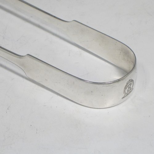 Antique Georgian sterling silver Fiddle pattern pair of asparagus serving tongs, having hand-pierced blades, and original retaining guard with screws. Made by William Eley of London in 1828. The dimensions of this fine hand-made silver pair of asparagus tongs are length 24 cms (9.5 inches), and it weighs approx. 162g (5.2 troy ounces). Please note that this item is crested.