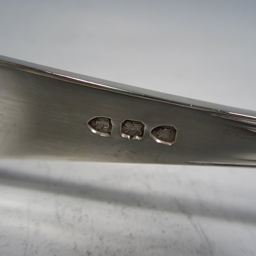 An Antique Victorian sterling silver Old English Thread pattern pair of pretty asparagus serving tongs, having hand-pierced blades with floral decoration, and original retaining guard with screw. Made by Edward Hutton of London in 1892. The dimensions of this fine pair of antique silver asparagus servers are length 24 cms (9.5 inches), and they weigh approx. 151g (4.9 troy ounces).