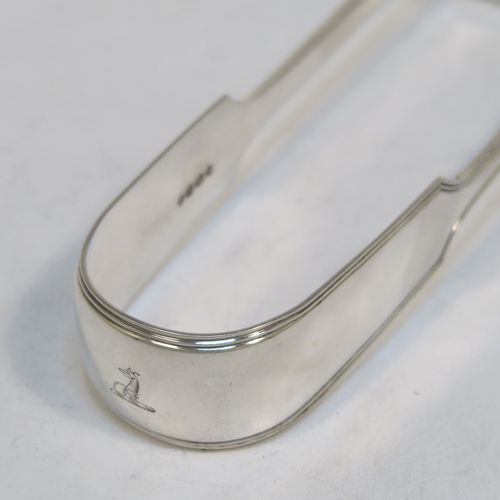 A very handsome and crisp Antique Victorian Sterling Silver Fiddle and Thread pattern pair of asparagus serving tongs, having hand-pierced blades, and an original retaining guard with screws. This elegant antique silver pair of asparagus tongs was made by William Smily of London in 1855. The dimensions of this fine pair of antique silver asparagus servers are length 26 cms (10.25 inches), and they weigh approx. 186g (6 troy ounces). Please note that this item is part crested.