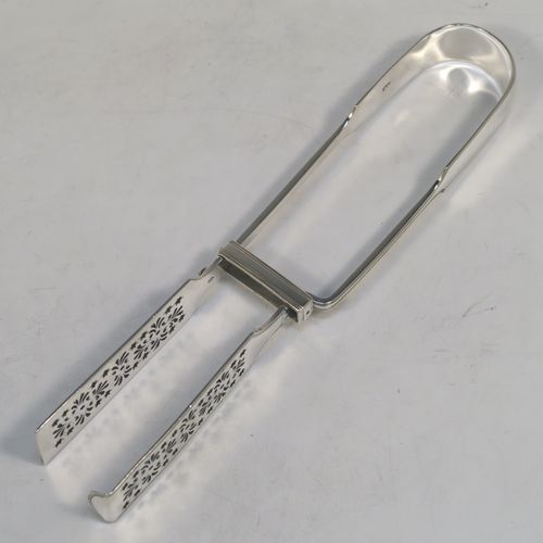 A very handsome and crisp Antique Victorian Sterling Silver Fiddle and Thread pattern pair of asparagus serving tongs, having hand-pierced blades, and an original retaining guard with screws. This elegant antique silver pair of asparagus tongs was made by William Smily of London in 1855. The dimensions of this fine pair of antique silver asparagus servers are length 26 cms (10.25 inches), and they weigh approx. 186g (6 troy ounces). Please note that this item is part crested.