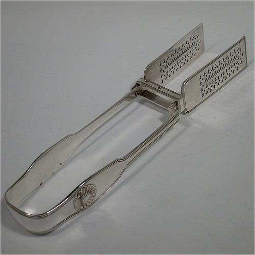 An Antique Victorian Sterling Silver pair of large asparagus serving tongs, in the Fiddle Thread and Shell pattern, having hand-pierced blades with floral and star-cut decoration, and original retaining guard with screws. Made by William Knight of London in 1840. The dimensions of this fine pair of antique silver asparagus servers are length 28 cms (11 inches), and they weigh approx. 237g (7.6 troy ounces).    