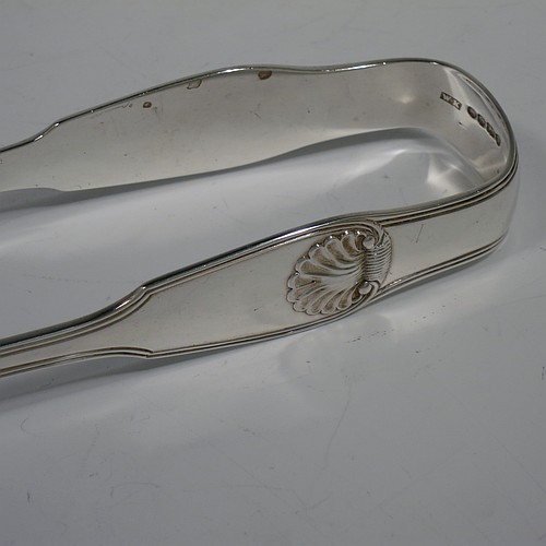 An Antique Victorian Sterling Silver pair of large asparagus serving tongs, in the Fiddle Thread and Shell pattern, having hand-pierced blades with floral and star-cut decoration, and original retaining guard with screws. Made by William Knight of London in 1840. The dimensions of this fine pair of antique silver asparagus servers are length 28 cms (11 inches), and they weigh approx. 237g (7.6 troy ounces).