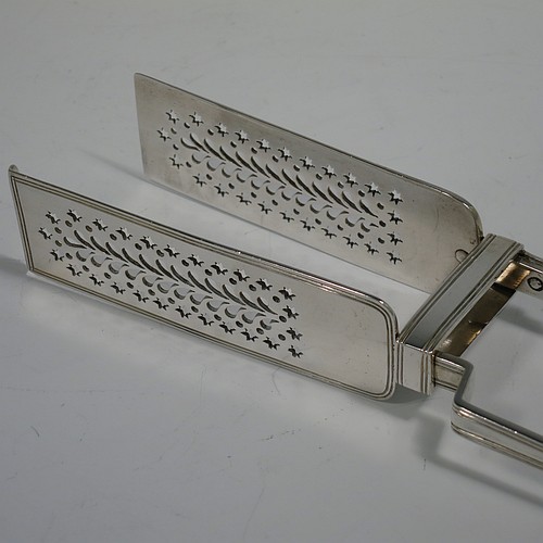 An Antique Victorian Sterling Silver pair of large asparagus serving tongs, in the Fiddle Thread and Shell pattern, having hand-pierced blades with floral and star-cut decoration, and original retaining guard with screws. Made by William Knight of London in 1840. The dimensions of this fine pair of antique silver asparagus servers are length 28 cms (11 inches), and they weigh approx. 237g (7.6 troy ounces).