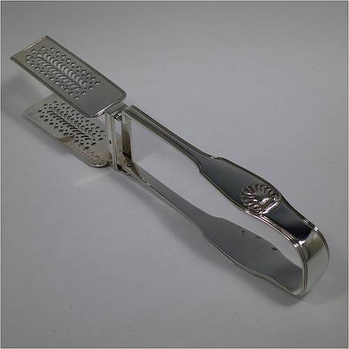 An Antique Victorian Sterling Silver pair of large asparagus serving tongs, in the Fiddle Thread and Shell pattern, having hand-pierced blades with floral and star-cut decoration, and original retaining guard with screws. Made by William Knight of London in 1840. The dimensions of this fine pair of antique silver asparagus servers are length 28 cms (11 inches), and they weigh approx. 237g (7.6 troy ounces).