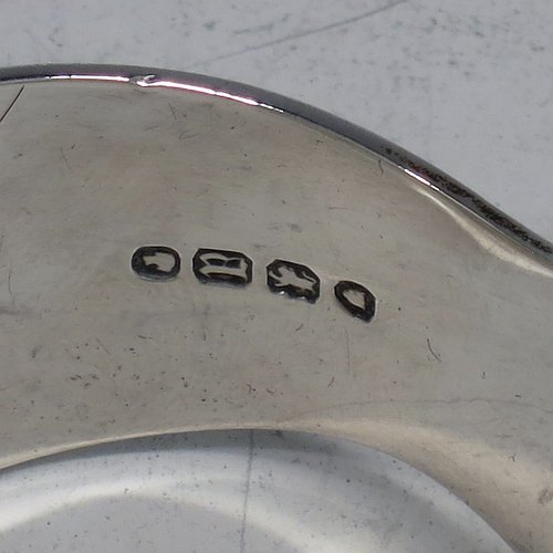 An Antique Victorian Sterling Silver pair of asparagus serving tongs, in the Fiddle, Thread, & Shell pattern, having hand-pierced blades, and original retaining guard with screws. Made by George Adams of London in 1856. The dimensions of this fine pair of antique silver asparagus servers are length 25 cms (9.75 inches), and they weigh approx. 223g (7.2 troy ounces). Please note that this item is crested.