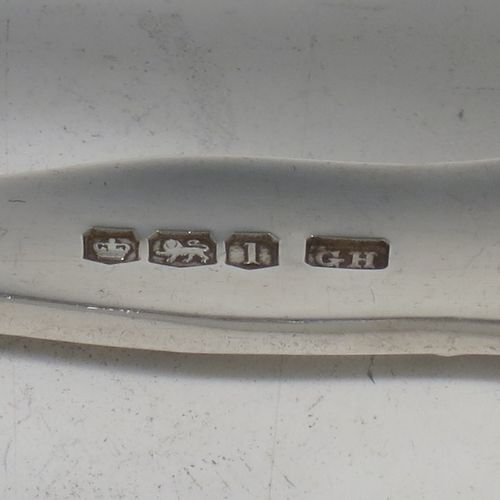 A handsome Sterling Silver pair of asparagus serving tongs, in the Kings pattern, having plain hand-pierced blades, and original retaining guard with screw. Made by George Hancock of Sheffield in 1928. The dimensions of this fine pair of silver asparagus servers are length 19 cms (7.5 inches), and they weigh approx. 148g (4.8 troy ounces).