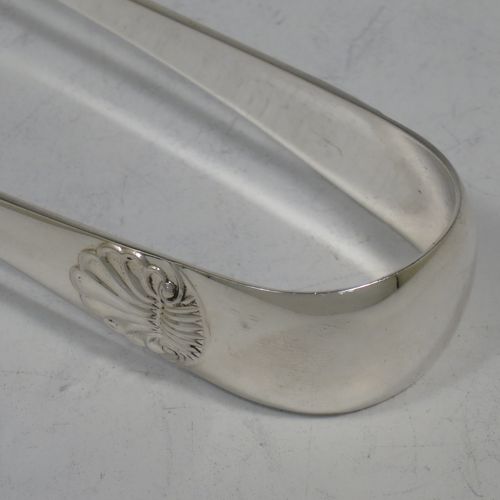 A handsome Antique Victorian Sterling Silver pair of large asparagus serving tongs, in the Old English and Shell pattern, having hand-pierced blades with hand-engraved reeded decoration, and original retaining guard with screw. Made by George Hancock of Sheffield in 1901. The dimensions of this fine hand-made pair of antique silver asparagus servers are length 23 cms (9 inches), and they weigh approx. 142g (4.5 troy ounces).