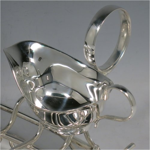 An Antique Edwardian Silver Plated asparagus serving set, having a plain oval body, with an applied rounded border, an original wire-work serving rack, a sauce boat sat in a frame with loop handle, and all sitting on a flat base. Made by Charles Green & Co., of Sheffield in ca. 1900. The dimensions of this fine hand-made silver-plated asparagus serving set are length 34 cms (13.5 inches), and width, 19 cms (7.5 inches).