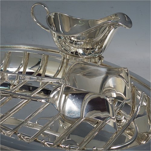 A Silver Plated asparagus serving set, having a plain oval body, with an applied rounded border, an original wire-work serving rack, a pair of plain serving tongs, and a sauce boat sat in a frame with loop handle, and all sitting on a flat base. Made by Deakin & Frances of Sheffield in ca. 1920. The dimensions of this fine hand-made silver-plated asparagus serving set are length 30.5 cms (12 inches), and width, 19.5 cms (7.75 inches).