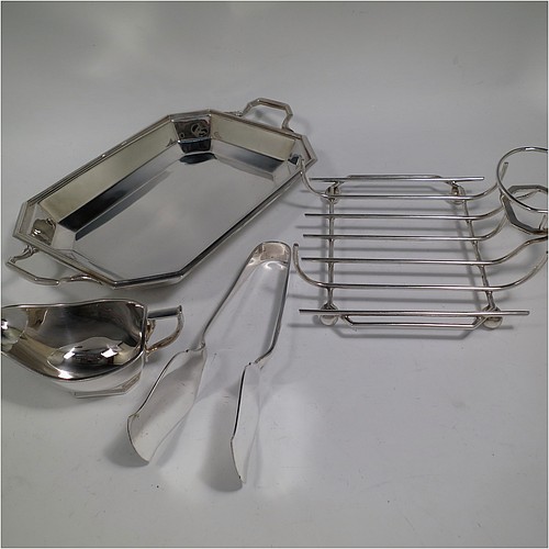 An Art Deco style Silver Plated asparagus serving set, having a plain elongated octagonal body, with an applied reeded border and two cast side-handles, a wire-work serving rack, a sauce boat sat in a frame with loop handle, a pair of asparagus server tongs, and all sitting on a flat base. All pieces are original and were made in England, circa 1930. The dimensions of this fine hand-made silver-plated Art Deco asparagus serving set are length 32.5 cms (12.75 inches), and width, 20 cms (8 inches).
